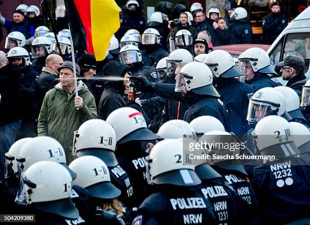Police use pepper spray to control supporters of Pegida, Hogesa and other right-wing populist groups as they protest against the New Year's Eve sex...