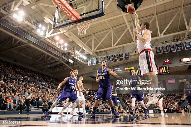 Ryan Edwards of the Gonzaga Bulldogs puts up a shot against Jason Todd, Ray Barreno and Bryce Pressley of the Portland Pilots in the first half of...