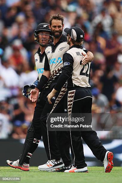 Grant Elliott of the Black Caps celebrates with Luke Ronchi and Kane Williamson after claiming the wicket of Tillakaratne Dilshan of Sri Lanka during...