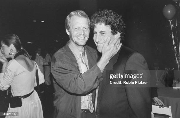 Former co-stars of TV's Starsky and Hutch, actors David Soul and Paul Michael Glaser greeting each other affectionately at a benefit screening of the...
