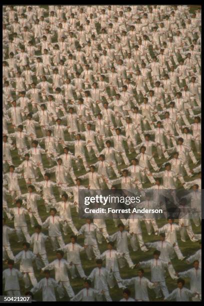 Performers, all in white, doing number during dress rehearsal for Asian Games opening ceremony.;1990;AMES