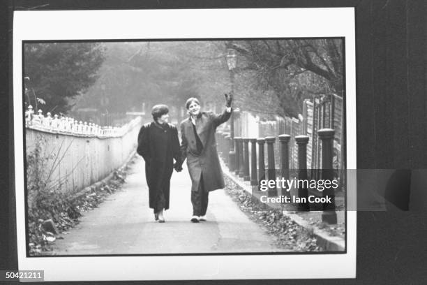 Author Michael Lewis walking w. His wife Diane through a park.