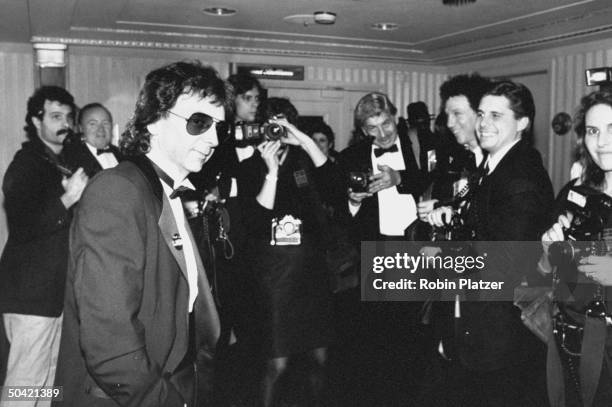 Record producer Phil Spector surrounded by news photographers as he arrives at the Rock & Roll Hall of Fame induction banquet at the Waldorf-Astoria...