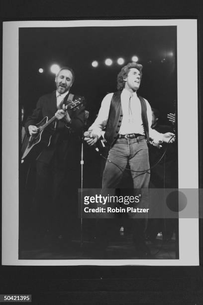 Guitarist Peter Townshend w. Singer Roger Daltrey of The Who, performing on stage during the Rock & Roll Hall of Fame induction ceremony at the...