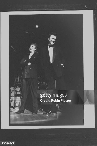 Rock singers Graham Nash & Ray Davies performing on stage during the Rock & Roll Hall of Fame induction ceremony at the Waldorf-Astoria Hotel.