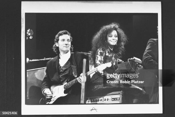 Rock singer Bruce Springsteen performing w. Singer Diana Ross on stage during the Rock & Roll Hall of Fame induction ceremony in the Waldorf-Astoria...