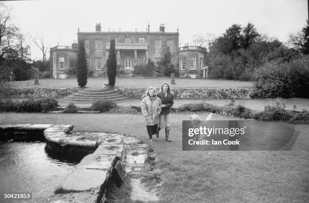 Maria St. Just , former friend of playwright Tennessee Williams, walking on her grounds w. Daughter Natasha; seen from afar.