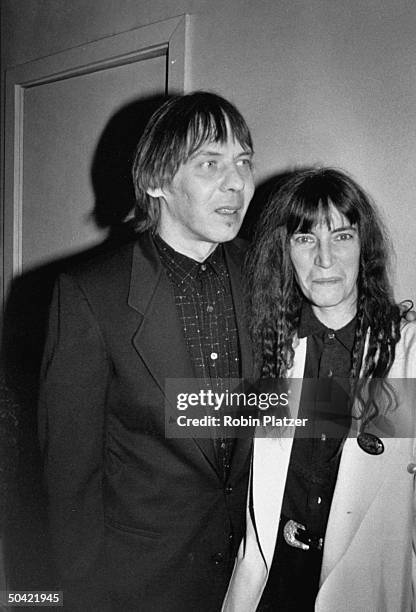 Avant-garde rock artist Patti Smith w. Husband Fred Sonic Smith at Arista Records 15th anniversary bash to raise money for AIDS.