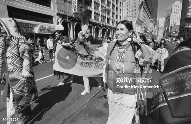 Actress/American Indian activist Sacheen Littlefeather adorned w. Tribal, beaded pigtail decorations & feather in her hair as she wears a down jacket...