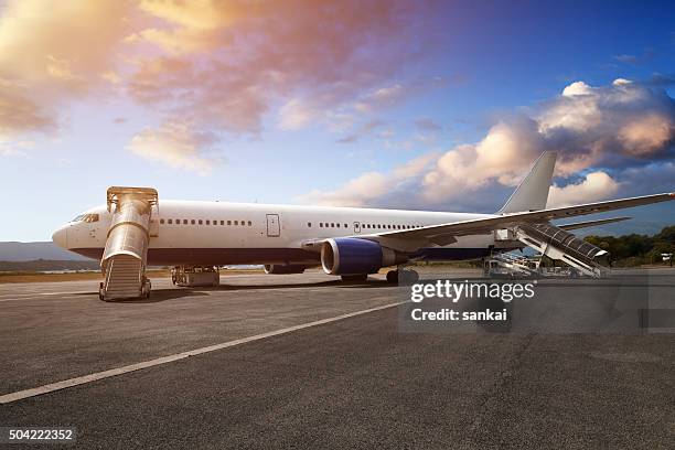 preparations of passenger jet airplane in airport in the evening - cubbyhole stock pictures, royalty-free photos & images