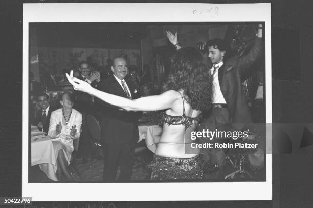 Saudi arms dealer Adnan Khashoggi ogling belly dancer Nadia as he steps towards her inviting gyrations at the trial victory party he & Imelda Marcos...