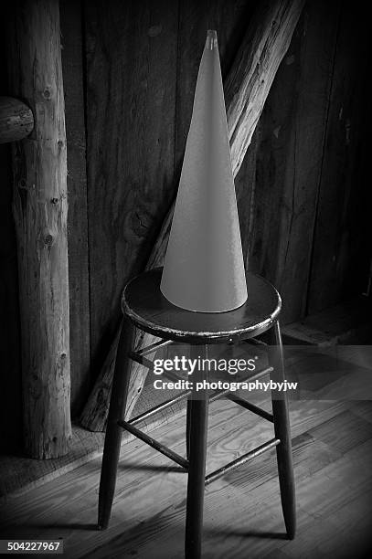 dunce cap on stool - dunce cap stock-fotos und bilder