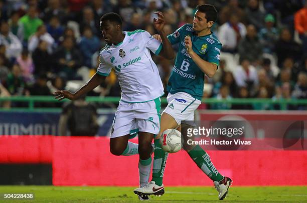 Jorge Tavares of Santos Laguna struggles for the ball with Guillermo Burdisso of Leon during the 1st round match between Leon and Santos Laguna as...
