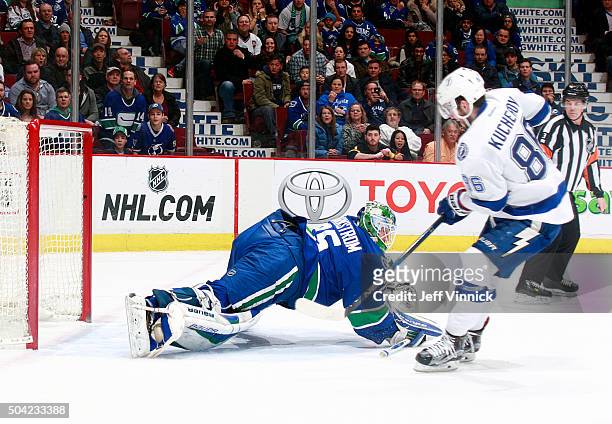 Nikita Kucherov of the Tampa Bay Lightning scores in overtime on Jacob Markstrom of the Vancouver Canucks during their NHL game January 9, 2016 in...