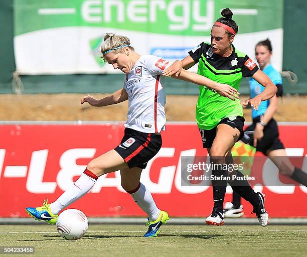 Caitlin Cooper of the Wanderers and Emma Kete of Canberra United contest possession during the round 13 W-League match between Canberra United and...