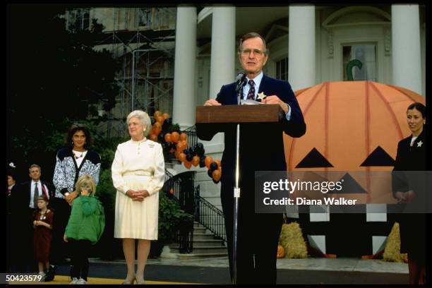 Pres. & Barbara Bush officiating at WH Halloween fete flanked by Marilyn Quayle , daughter-in-law Margaret & granddaughter Marshall .