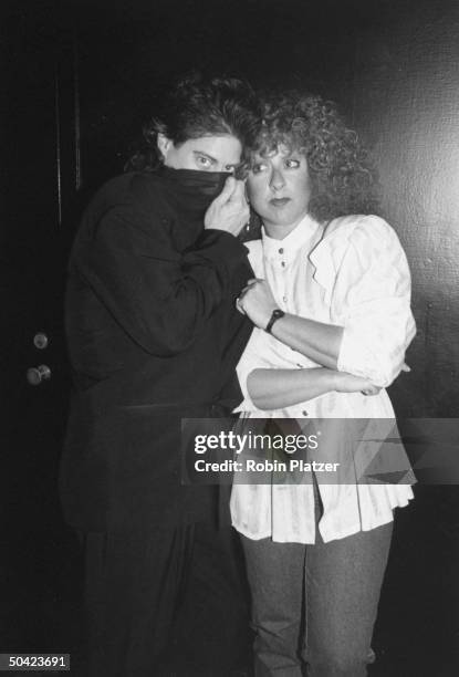 Comedian Richard Lewis peeking over his jacket lapel as he poses incognito w. Comedienne Elaine Boosler at party for HBO's Comic Relief IV, a...