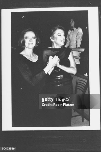 Actress Maggie Smith w. Actress Tyne Daly holding hands at Tony Awards party at the New York Hilton hotel.