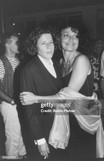 Fashion designer Diane Von Furstenburg hugging author Fran Lebowitz at book party.