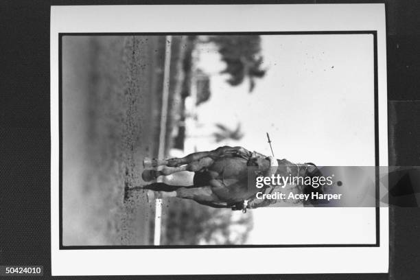 Jockey Pat Day riding horse called Once Wild down muddy track during Breeder's Cup race.