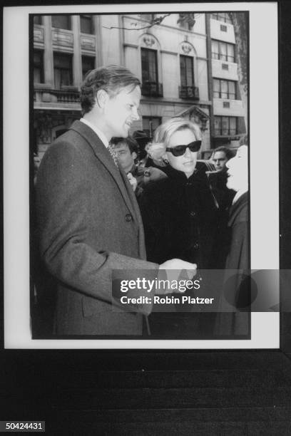 Paley's stepson Tony Mortimer and wife Siri chatting w. Unindent woman before entering Temple for William S. Paley's funeral.