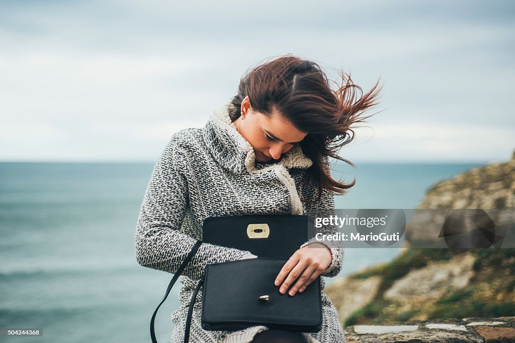 Young woman searching in her purse