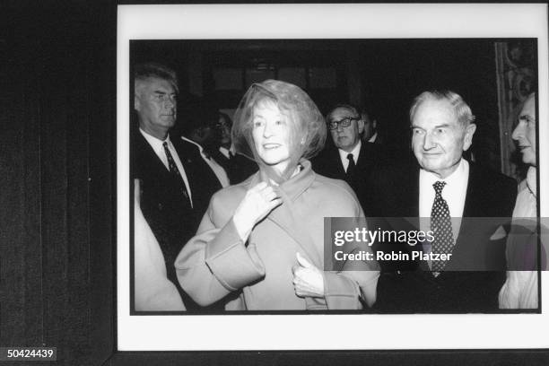 Banker David Rockefeller w. Socialite Marietta Tree, followed by Henry Kissinger, as they leave Temple where William S. Paley funeral was conducted.