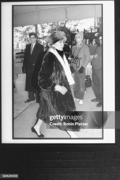 Actress-socialite Cornelia Sharpe Bregman in fur hat and coat, entering Temple for William S. Paley's funeral, NYC.