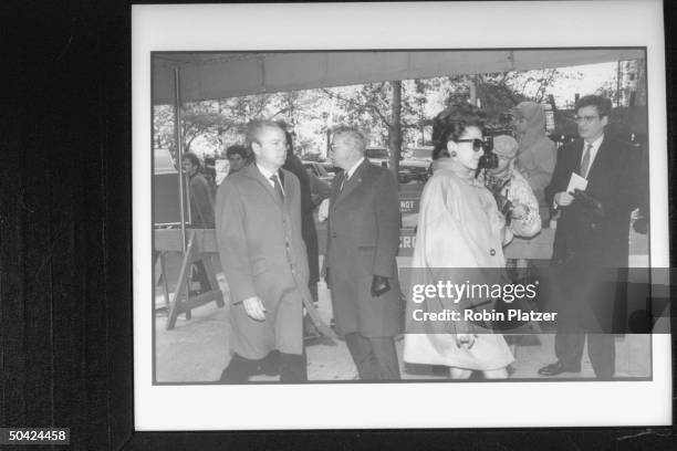 Corporate raider Sid Bass following his wife Mercedes into Temple for William S. Paley's funeral.