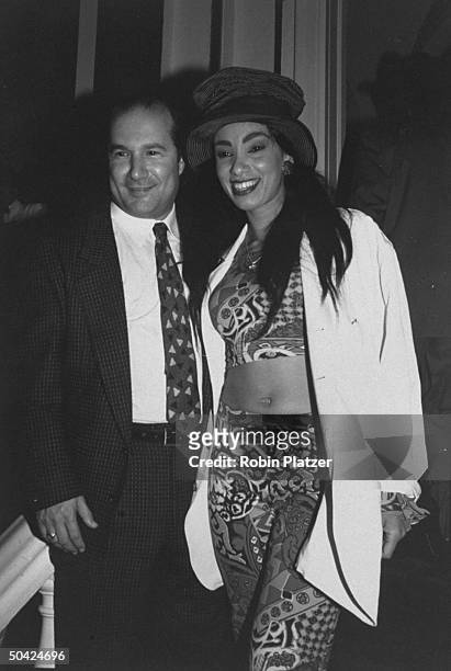 Video disc jockey Downtown Julie Brown w. An unident. Man at a party to celebrate the Grammy Awards.