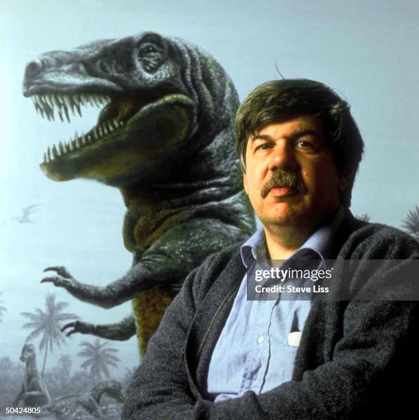 Paleontologist Stephen Jay Gould, w. Mural of dinosaur Tyrannosaurus Rex in bkgrd.