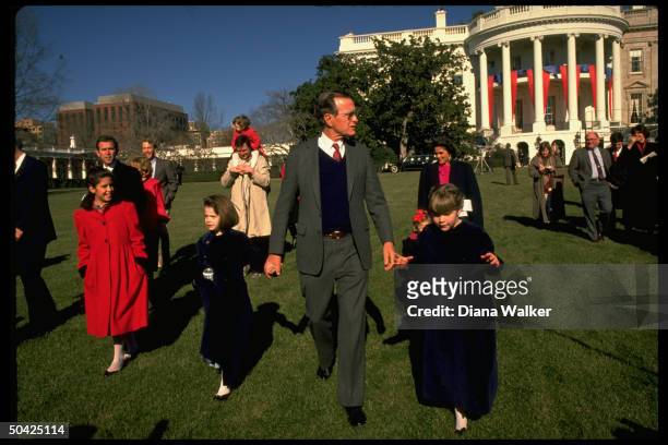 Pres. Bush holding hands w. Granddaughters, w. Sons & spouses Margaret & Marvin, Neil & Sharon, George & progeny in tow, feting inaugural on WH lawn.