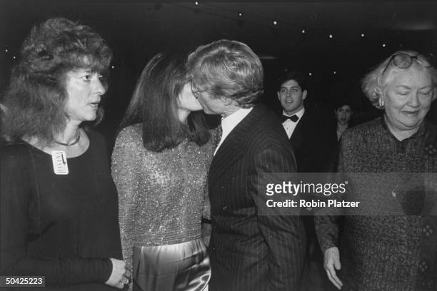 Actor Robert Redford kissing his co-star Lena Olin goodbye at premiere of Havana.