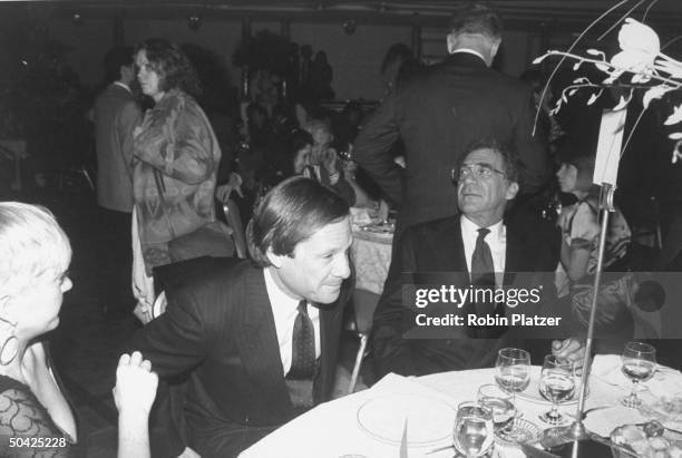 Pres. Of Creative Artists Agency Michael Ovitz w. Director Sydney Pollack at table, at premiere of Havana.