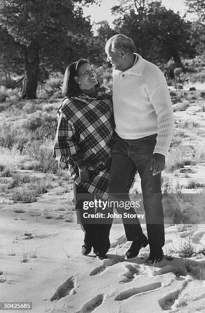 Myrlie Evers, widow of slain civil rights leader Medgar Evers, walking in the snow w. Her husband, civil rights activist Walter Williams during their...