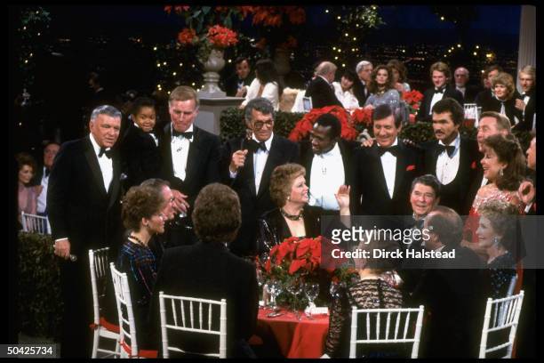 Sinatra, Lewis, Heston, Martin, Vereen, Hall, Reynolds, Scully, Gorme, Lawrence; at table Nancy, Ron & Maureen Reagan & Revell at fete honoring...