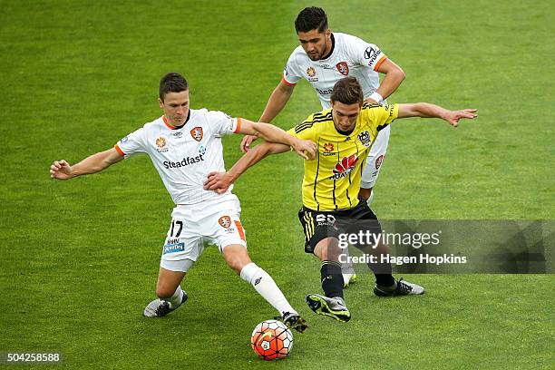 Matthew Ridenton of the Phoenix attempts to win the ball from Matt McKay and Dimitri Petratos of the Roar during the round 14 A-League match between...