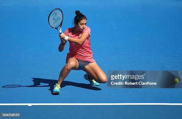 Zarina Diyas of Kazakhstan plays a backhand in the women's singles match against Camila Giorgi of Italy during day one of 2016 Hobart International...