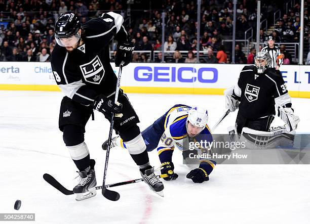 Alexander Steen of the St. Louis Blues attempts a stick check from behind on Drew Doughty of the Los Angeles Kings as Jonathan Quick looks on during...