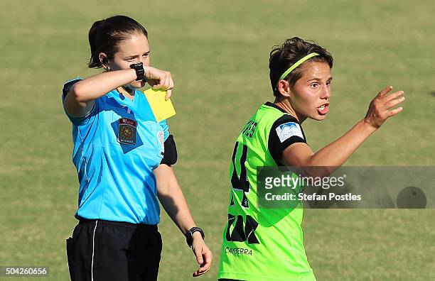 Ashleigh Sykes of Canberra United receives a yellow card from Referee Rebecca Durcau during the round 13 W-League match between Canberra United and...
