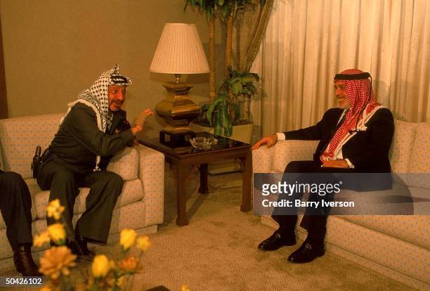 King Hussein seated mtg. W. Holstered gun sporting PLO Chmn. Yasser Arafat, on eve of gulf crisis deadline.