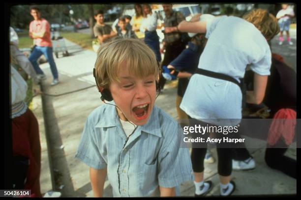 Chld actor Macaulay Culkin screaming on set of My Girl, w. Crew, et all in rear.