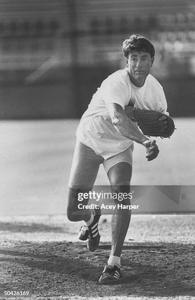 Former baseball pitcher Jim Palmer on mound pitching baseball during practice for comeback into the game professionally at age 45. University of...