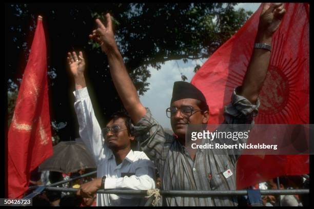 Communist Party of Nepal General Secretary Madan Bhandari , veeing fingers, on stump, framed by CPM UML red flags, candidate in first free election...