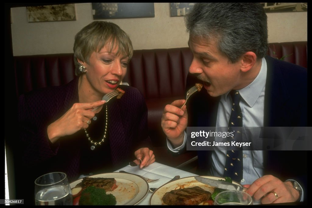 Unidentified couple, eating steak, forks