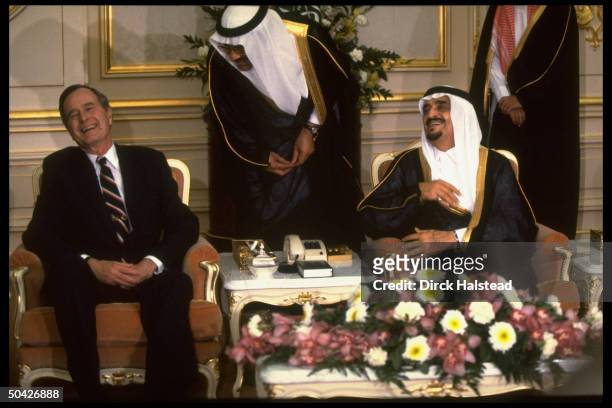 Pres. George Bush laughing during mtg. W. Saudi King Fahd, w. Interpreter between, during diplomatic tour during gulf crisis.