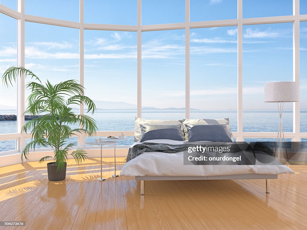 Moderne Schlafzimmer-Interieur mit Fenster über Wolkengebilde das Meer
