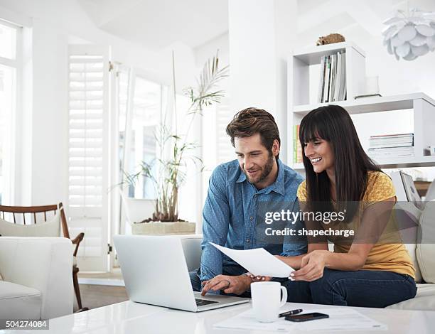 checking on their investments - looking at bill home stock pictures, royalty-free photos & images