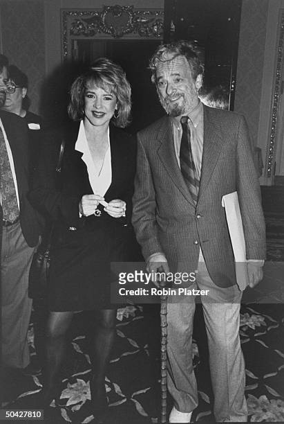 Musical theater composer Stephen Sondheim standing w. Actress Stockard Channing at party.