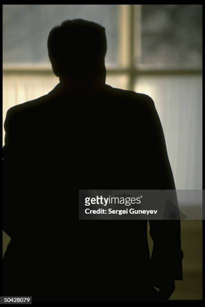 Russian Republic ldr. Boris Yeltsin, looking out window, in silhouette, at Congress of People's Deputies.